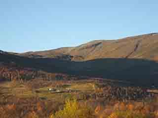 Farm nestles in highland cirque (autumn) (Fjellbygda, Norway)