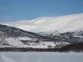 Farm nestles in highland cirque (winter) (Fjellbygda, Norway)