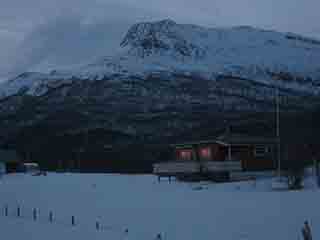 Late-night sunset glints off windows (Sand, Norway)