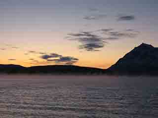 Amber end-of-year sunset with sea fog (From Mortenhals, Norway)