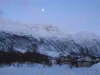 Moon over mid-blue Nordkjosbotn peaks (From Nordkjosbotn VGS, Norway)